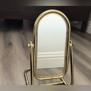 Freestanding gold metal arch vanity mirror